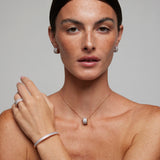 Bracciale rigido in argento rosa con zirconi bianchi